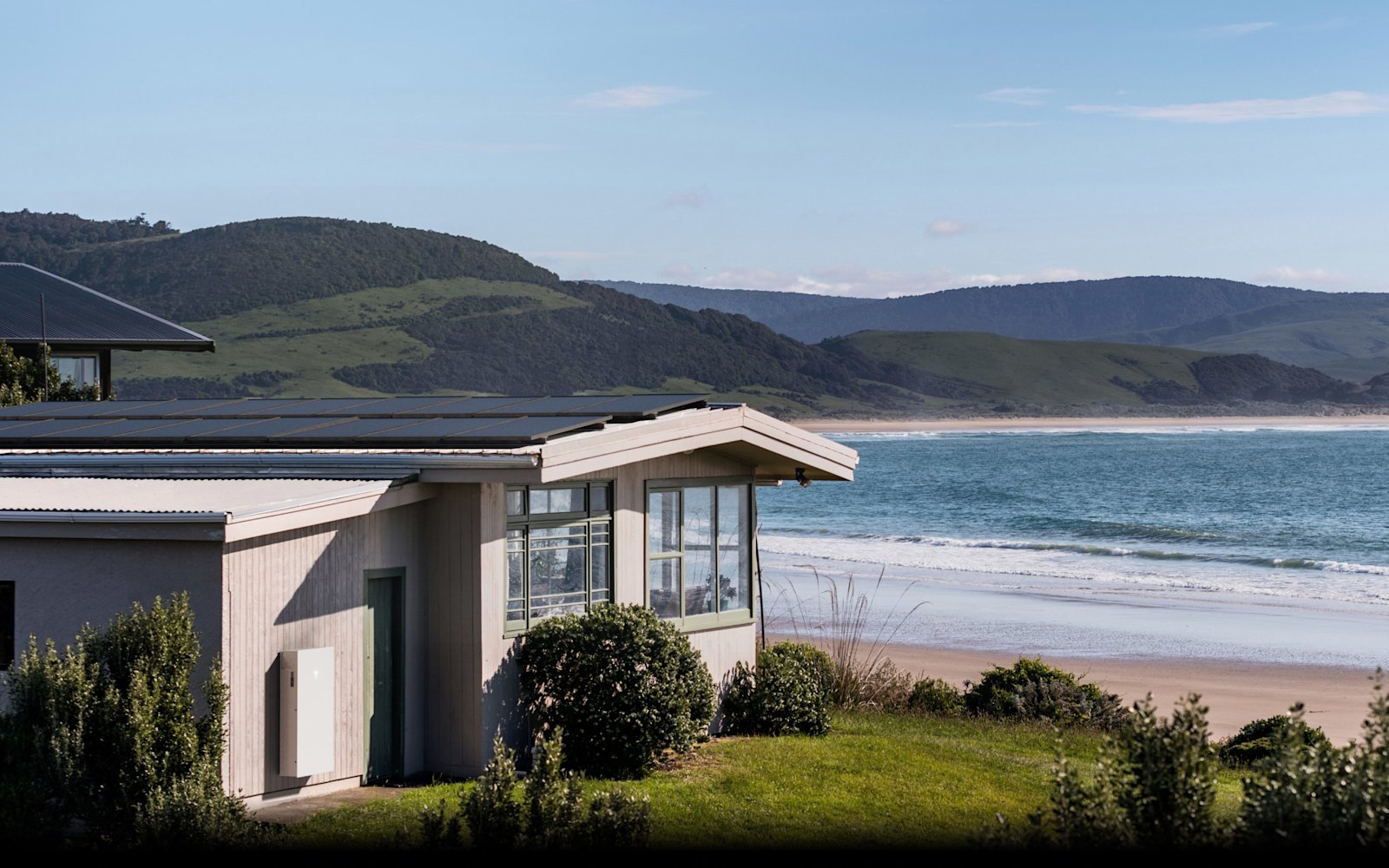 Home with rooftop solar and a wall-mounted Tesla Powerwall 3, Tesla manufacturer photo